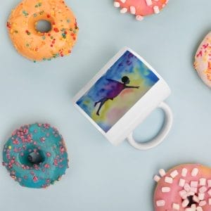 A ReachingMyDreams signature icon on a White glossy mug with a picture of a person running on it next to some donuts.